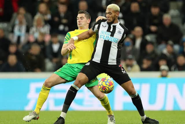 Kenny McLean of Norwich City vies wit Joelinton of Newcastle United during the Premier League match between Newcastle United and Norwich City at St. James Park on November 30, 2021.