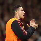  Cristiano Ronaldo of Manchester United warms up on the touchline during the Premier League match  (Photo by Alex Pantling/Getty Images)