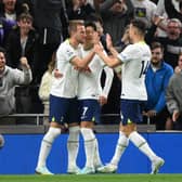 Harry Kane of Tottenham Hotspur celebrates with teammates after scoring their team's first goal from the penalty spot during the Premier League match