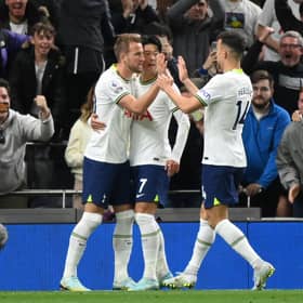 Harry Kane of Tottenham Hotspur celebrates with teammates after scoring their team's first goal from the penalty spot during the Premier League match
