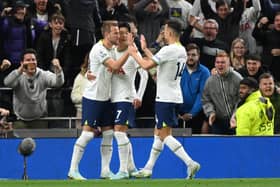 Harry Kane of Tottenham Hotspur celebrates with teammates after scoring their team's first goal from the penalty spot during the Premier League match