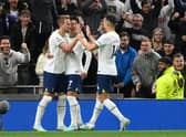 Harry Kane of Tottenham Hotspur celebrates with teammates after scoring their team's first goal from the penalty spot during the Premier League match
