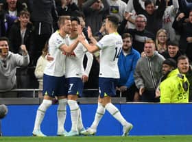Harry Kane of Tottenham Hotspur celebrates with teammates after scoring their team's first goal from the penalty spot during the Premier League match