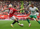 Diogo Dalot of Manchester United is challenged by Dan Burn of Newcastle United  (Photo by Dan Mullan/Getty Images)