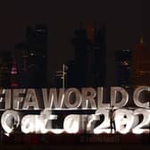 Fans gather at the Corniche next to the FIFA World Cup logo on November 20, 2022 in Doha, Qatar. 