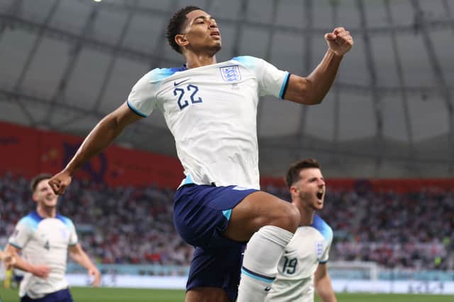 England's midfielder #22 Jude Bellingham celebrates scoring his team's first goal during the Qatar 2022 World Cup Group B football match between England and Iran at the Khalifa International Stadium in Doha on November 21, 2022. (Photo by ADRIAN DENNIS / AFP) (Photo by ADRIAN DENNIS/AFP via Getty Images)