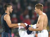 England’s midfielder Steven Gerrard (R).