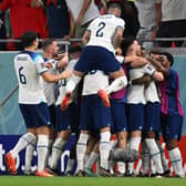 England players celebrate one of Marcus Rashford’s goals vs Wales.