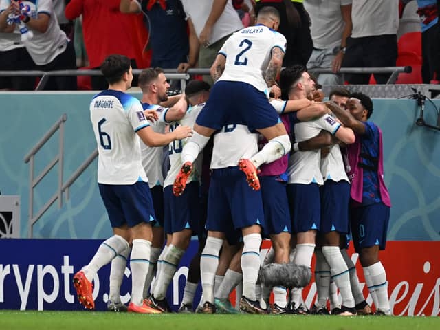 England players celebrate one of Marcus Rashford’s goals vs Wales.