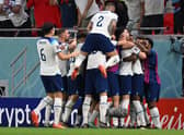 England players celebrate one of Marcus Rashford’s goals vs Wales.