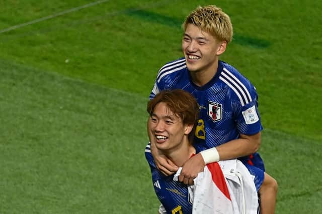 Japan celebrate their win over Spain in final Group E match