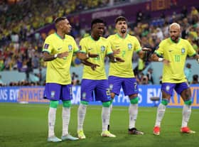 Vinicius Junior of Brazil celebrates with Raphinha, Lucas Paqueta and Neymar after scoring the team’s first goal during the (Photo by Michael Steele/Getty Images)