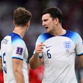John Stones (L) and Harry Maguire of England speak during the FIFA World Cup Qatar 2022 Group B match between Wales and England  (Photo by Justin Setterfield/Getty Images)