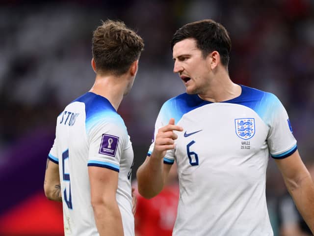 John Stones (L) and Harry Maguire of England speak during the FIFA World Cup Qatar 2022 Group B match between Wales and England  (Photo by Justin Setterfield/Getty Images)