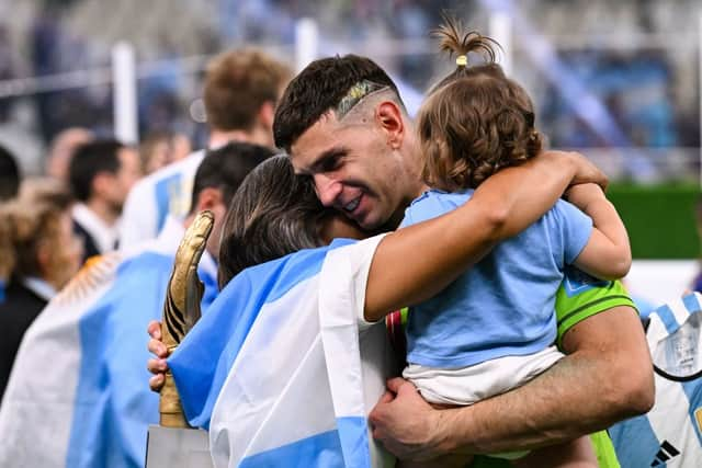  Emiliano Martinez holds the FIFA Golden Glove award as he celebrates with his wife Amanda Mandinha and daughter Ava after Argentina won the Qatar 2022 World Cup final football match between Argentina and France at Lusail Stadium in Lusail, north of Doha on December 18, 2022. (Photo by KIRILL KUDRYAVTSEV/AFP via Getty Images)