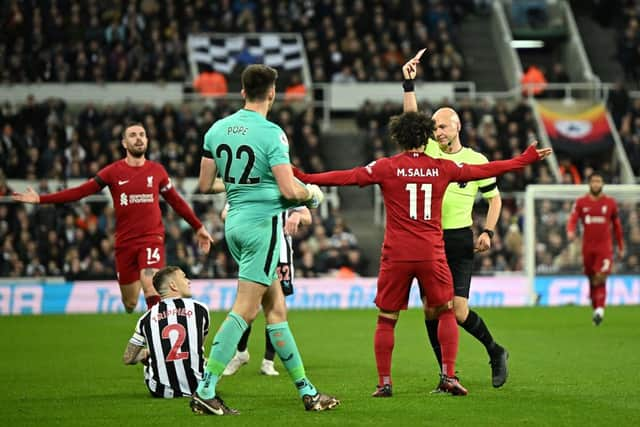 Newcastle United's English goalkeeper Nick Pope (front L) reacts after receiving a red card during the English Premier League football match between Newcastle United and Liverpool at St James' Park in Newcastle-upon-Tyne, north east England on February 18, 2023. - RESTRICTED TO EDITORIAL USE. No use with unauthorized audio, video, data, fixture lists, club/league logos or 'live' services. Online in-match use limited to 120 images. An additional 40 images may be used in extra time. No video emulation. Social media in-match use limited to 120 images. An additional 40 images may be used in extra time. No use in betting publications, games or single club/league/player publications. (Photo by Oli SCARFF / AFP) / RESTRICTED TO EDITORIAL USE. No use with unauthorized audio, video, data, fixture lists, club/league logos or 'live' services. Online in-match use limited to 120 images. An additional 40 images may be used in extra time. No video emulation. Social media in-match use limited to 120 images. An additional 40 images may be used in extra time. No use in betting publications, games or single club/league/player publications. / RESTRICTED TO EDITORIAL USE. No use with unauthorized audio, video, data, fixture lists, club/league logos or 'live' services. Online in-match use limited to 120 images. An additional 40 images may be used in extra time. No video emulation. Social media in-match use limited to 120 images. An additional 40 images may be used in extra time. No use in betting publications, games or single club/league/player publications. (Photo by OLI SCARFF/AFP via Getty Images)