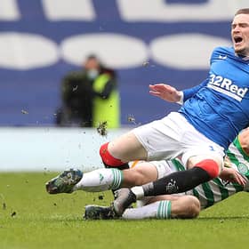 Scott Brown of Celtic fouls Ryan Kent of Rangers and earns a yellow card during a Scottish Cup tie in April 2021