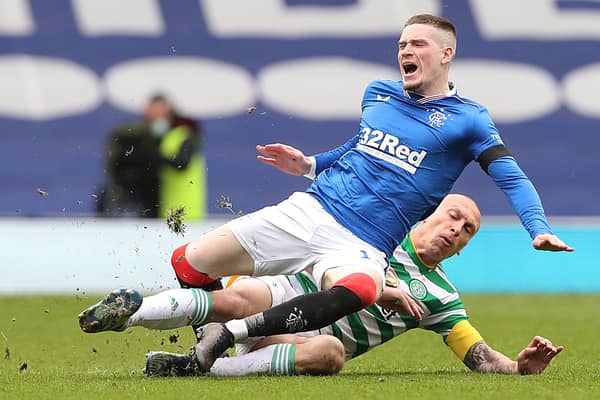 Scott Brown of Celtic fouls Ryan Kent of Rangers and earns a yellow card during a Scottish Cup tie in April 2021