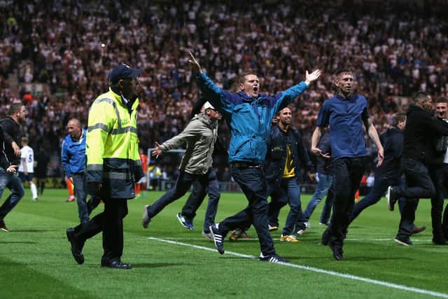 A 2013 pitch invasion during a League Cup game saw a steward trampled by a police horse.