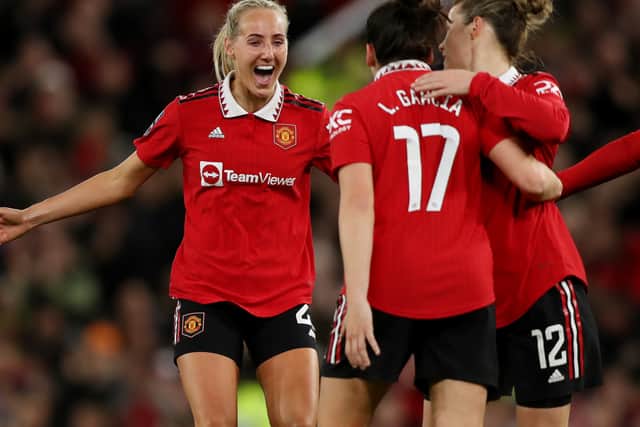 Millie Turner and Lucia Garcia celebrate - as well they might with Manchester United at the top of the table