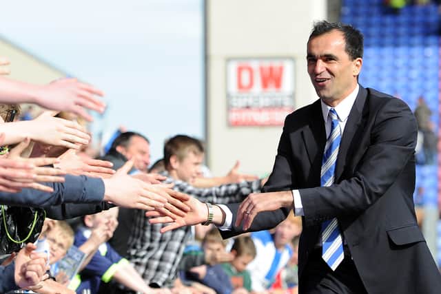 Roberto Martinez hands out the high fives after Wigan dodged the drop.
