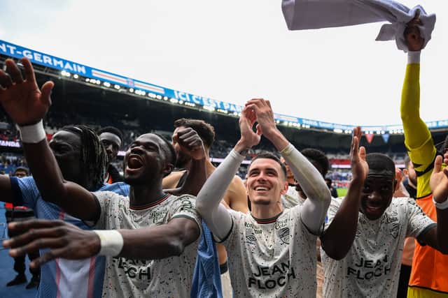 FC Lorient celebrate in front of their fans after their 3-1 win against PSG
