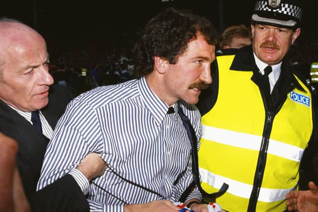 Souness is escorted from the field after winning the league title for Rangers in 1990.