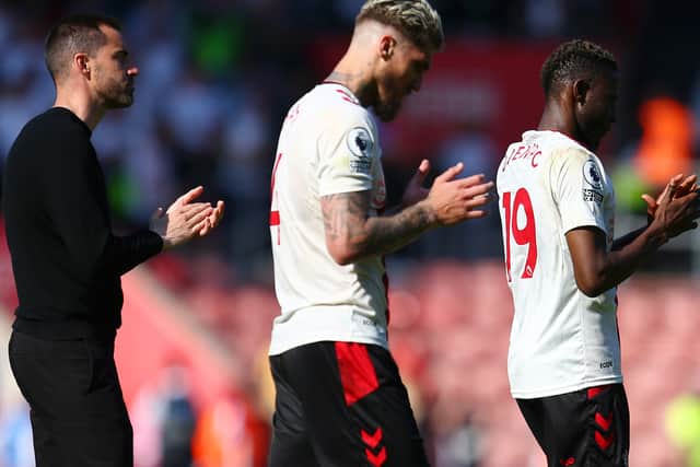 Rubén Sellés leads Lyanco and Moussa Djenepo from the field after defeat to Fulham. 