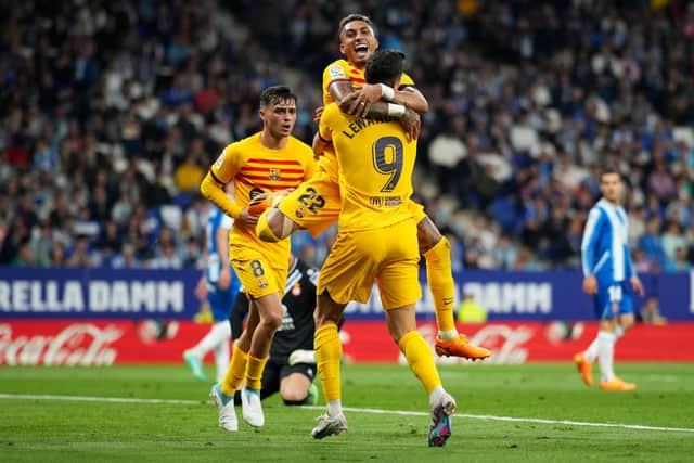 Robert Lewandowski celebrates scoring with teammate Raphinha