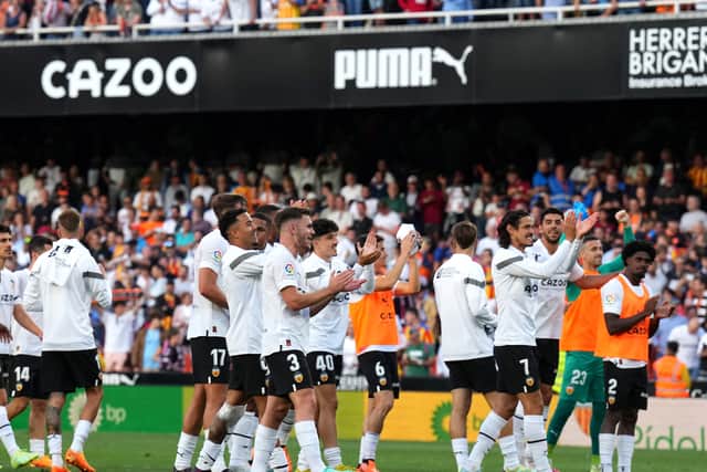 Valencia players applaud their fans after a key win over Real Madrid, which was marred by racist chanting.