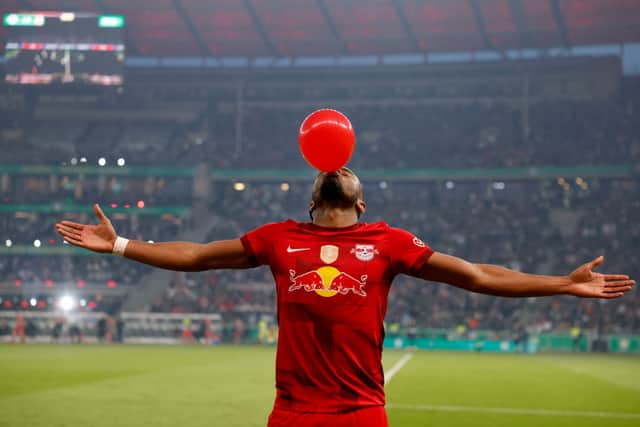 Leipzig's French forward Christopher Nkunku blows up a balloon as he celebrates after scoring the 1-0 goal (Photo by ODD ANDERSEN/AFP via Getty Images)