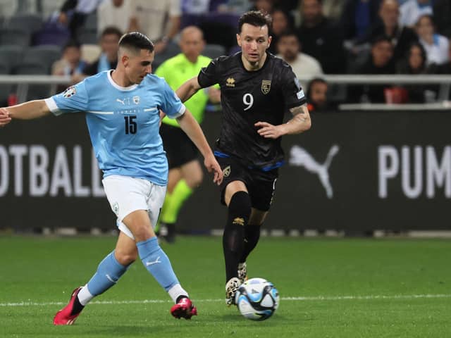 Israel’s midfielder Oscar Gloukh (L) is marked by Kosovo’s midfielder Bersant Celina during the UEFA Euro 2024 group  (Photo by JACK GUEZ/AFP via Getty Images)