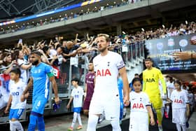 Anumanthan #6 of the Lion City Sailors and Harry Kane #10 of Tottenham Hotspur lead their teams (Photo by Yong Teck Lim/Getty Images)