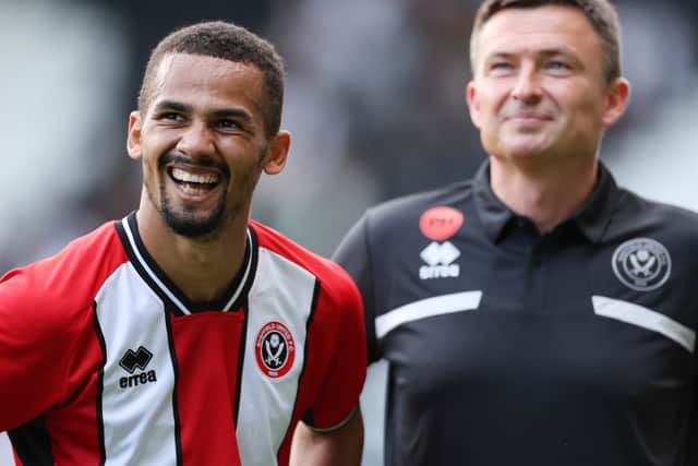 Iliman Ndiaye and Paul Heckingbottom share a joke during pre-season - but the Blades’ star player has since left for France.
