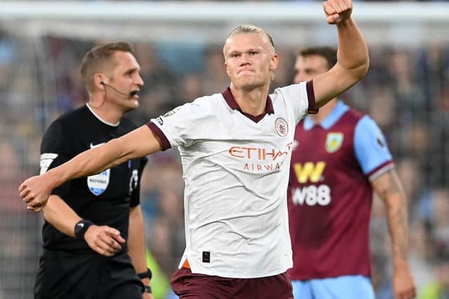 Erling Haaland celebrates his second goal at Turf Moor - not pictured, three Burnley players pumping their fists in the dugout.