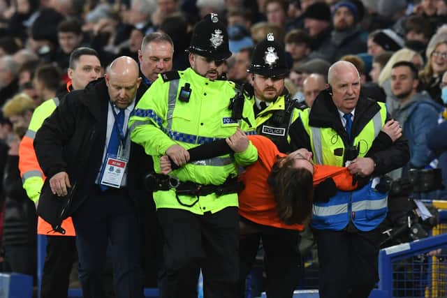 A Just Stop Oil protestor is dragged away by police after interrupting Everton’s game with Newcastle United.