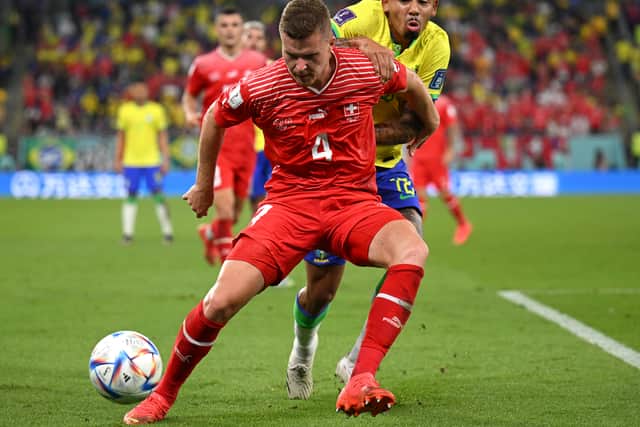 Nico Elvedi holds off the challenge of Gabriel Jesus during the 2022 World Cup match between Switzerland and Brazil.