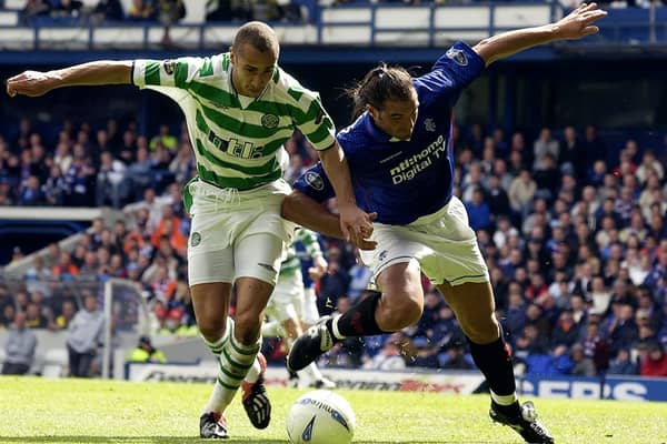  Henrik Larsson of Celtic is tackled by Lorenzo Amoruso of Rangers during the Bank of Scotland Scottish Premier League match between Glasgow Rangers and Glasgow Celtic held on April 27, 2003 at the Ibrox Stadium