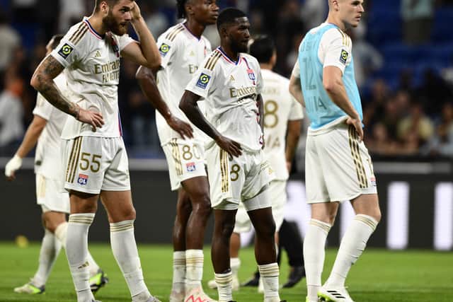 Lyon players prepare to receive their dressing-down after their 4-1 defeat to PSG.