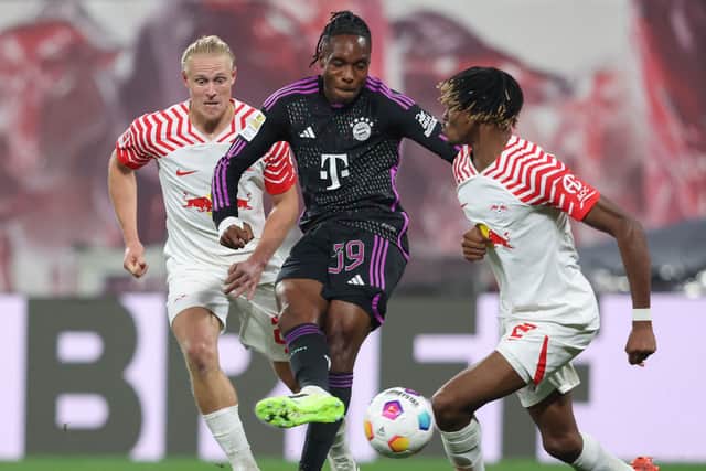 Mathys Tel gets the ball away under pressure during his substitute appearance against RB Leipzig.