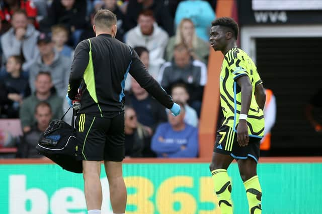 An injured Bukayo Saka is led from the field during the game against Bournemouth last weekend.