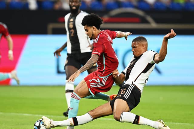 Thiaw slide tackles Liverpool’s Luis Díaz during an international friendly.