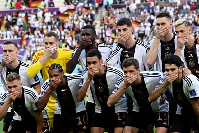 The German team covered their mouths in protest after being banned from wearing a rainbow armband during their World Cup matches in Qatar.