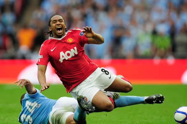 Manchester United’s Anderson feels the effects of a Nigel de Jong reducer.