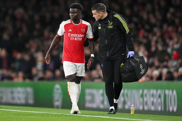Bukayo Saka is helped from the field after an injury against Sevilla.