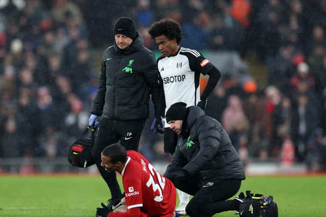 Joel Matip of Liverpool receives medical treatment during the Premier League match between Liverpool FC and Fulham FC at Anfield on December 03, 2023 in Liverpool, England. (Photo by Clive Brunskill/Getty Images)