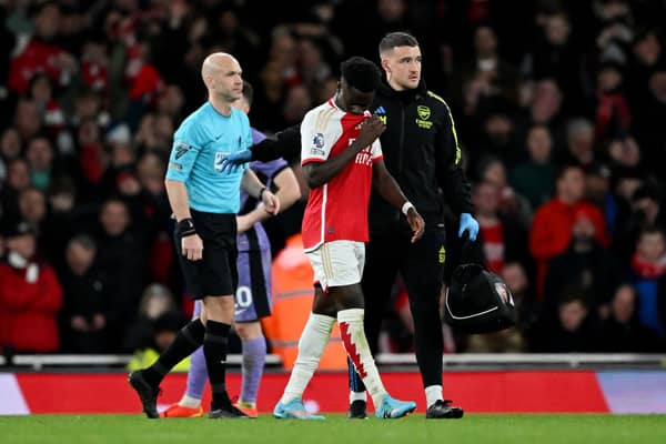 Arsenal winger Bukayo Saka is treated for an injury during the Gunners' Premier League win over Liverpool. The England international is expected to be fit enough to face West Ham this weekend. 