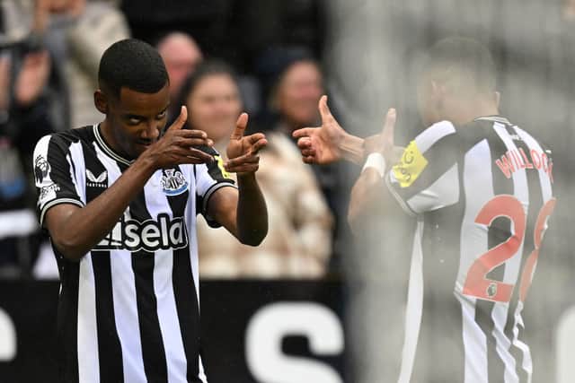 Newcastle United's Swedish striker #14 Alexander Isak (L) celebrates scoring the opening goal with Newcastle United's English midfielder #28 Joe Willock during the English Premier League football match between Newcastle United and Wolverhampton Wanderers at St James' Park in Newcastle-upon-Tyne, north east England on March 2, 2024. (Photo by Oli SCARFF / AFP)