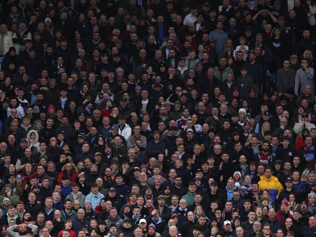 Aston Villa fans watch on at Villa Park.
