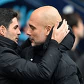 Mikel Arteta, Manager of Arsenal, interacts with Pep Guardiola, Manager of Manchester City